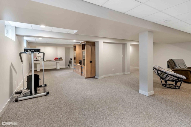exercise room featuring baseboards, recessed lighting, a paneled ceiling, and carpet