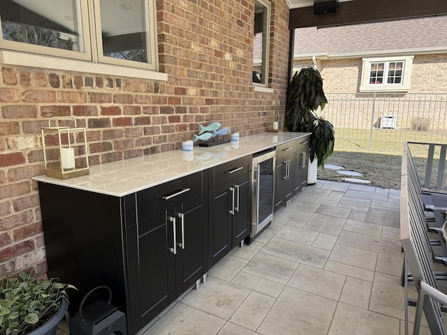 view of patio / terrace featuring beverage cooler, fence, and area for grilling