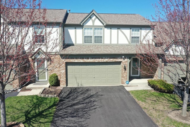 9208 Dexter Ct, Orland Park, IL 60462 - tudor-style house featuring stucco siding, aphalt driveway, brick siding, a garage, and a shingled roof