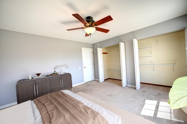 9208 Dexter Ct, Orland Park, IL 60462 - bedroom featuring a ceiling fan, visible vents, light carpet, multiple closets, and baseboards