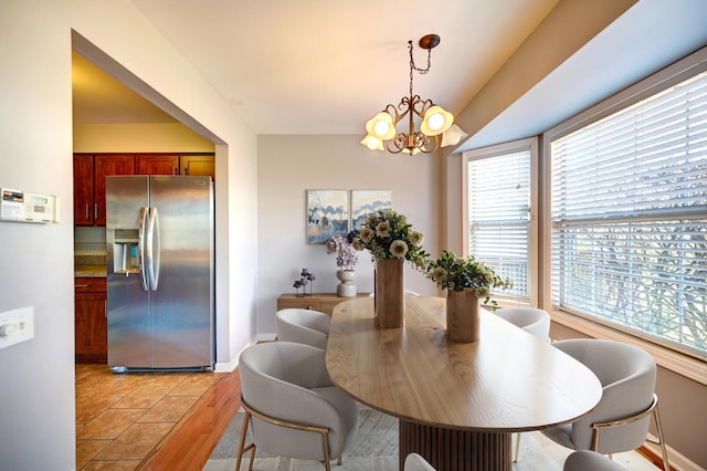 9208 Dexter Ct, Orland Park, IL 60462 - dining room featuring light wood-style flooring, a wealth of natural light, a chandelier, and baseboards