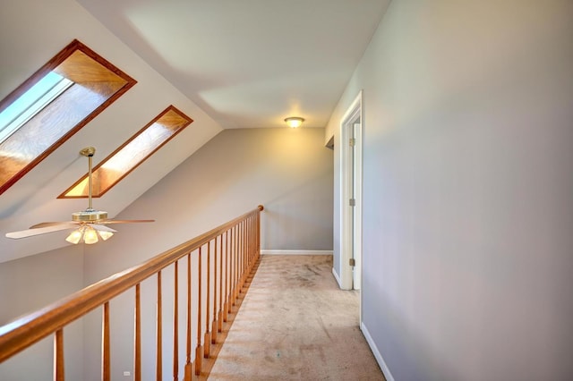 9208 Dexter Ct, Orland Park, IL 60462 - corridor featuring baseboards, lofted ceiling with skylight, and light carpet