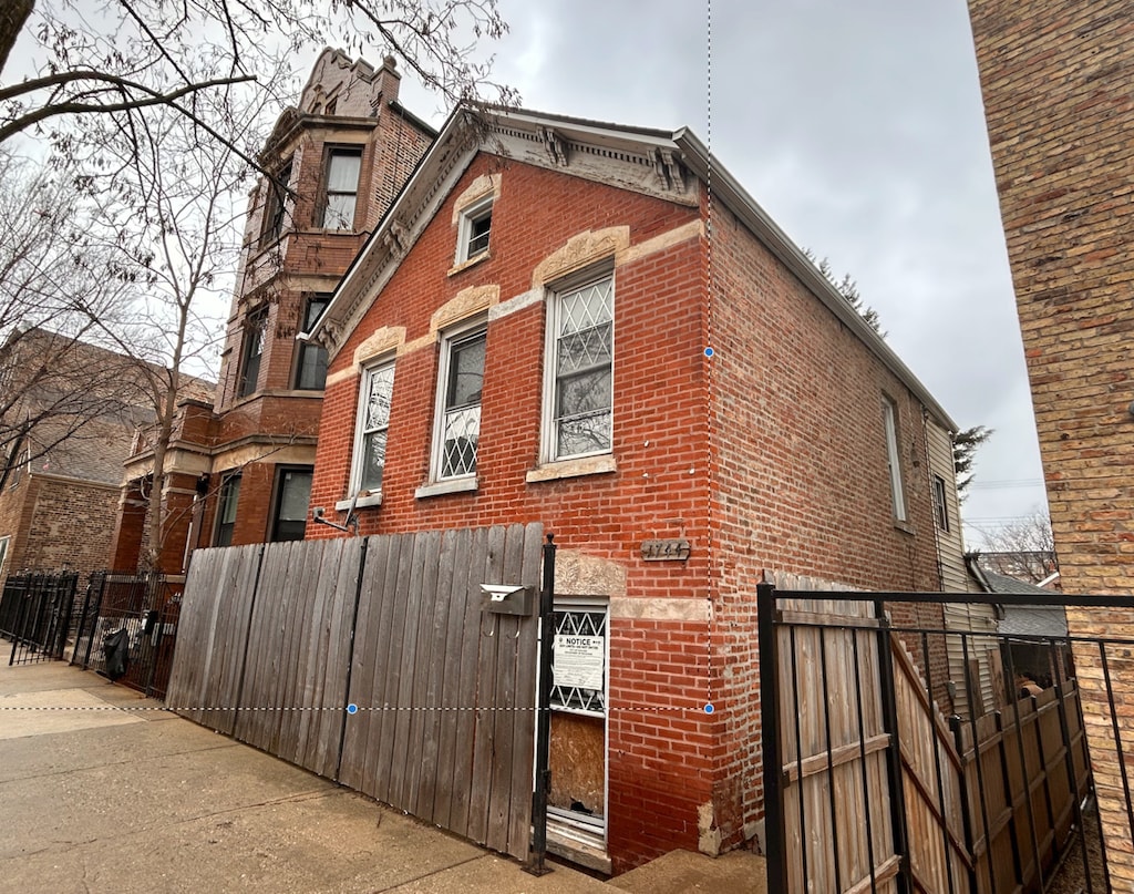 1744 W 17th St, Chicago, IL 60608 - view of home's exterior featuring brick siding and fence