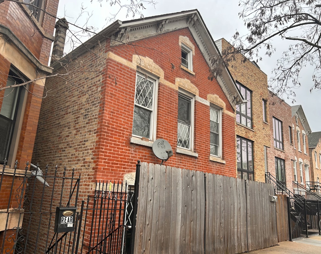 1744 W 17th St, Chicago, IL 60608 - view of side of property featuring brick siding and fence