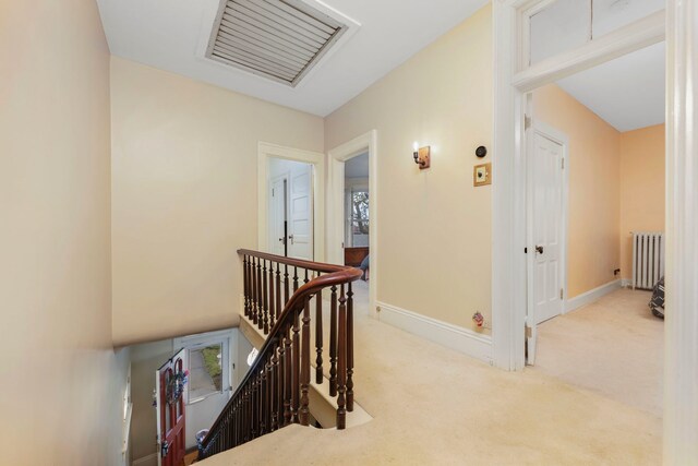 203 High St, West Chicago, IL 60185 - hallway featuring an upstairs landing, radiator heating unit, carpet floors, and baseboards