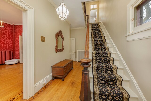 203 High St, West Chicago, IL 60185 - stairs featuring a chandelier, wood finished floors, radiator heating unit, crown molding, and plenty of natural light