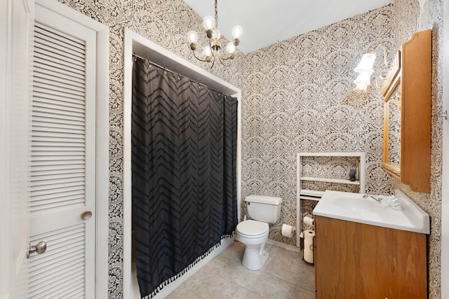 203 High St, West Chicago, IL 60185 - bathroom featuring vanity, toilet, tile patterned flooring, wallpapered walls, and a chandelier
