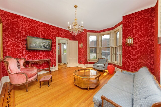 203 High St, West Chicago, IL 60185 - living room with wood finished floors, a chandelier, ornamental molding, baseboards, and wallpapered walls