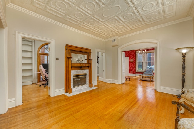 203 High St, West Chicago, IL 60185 - living room featuring light wood-style floors, a chandelier, a desk, baseboards, and an ornate ceiling