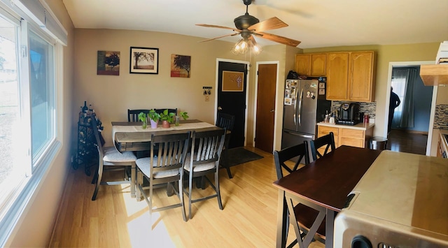 dining room featuring light wood finished floors and ceiling fan