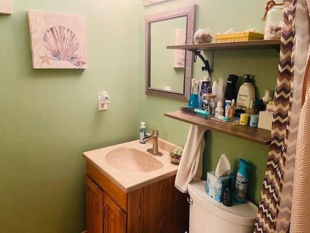 bathroom featuring toilet and vanity