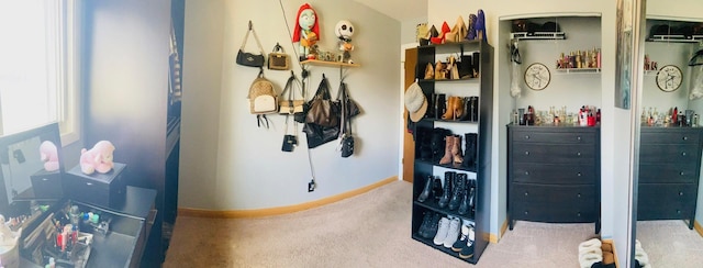 carpeted bedroom with a bar, baseboards, and a closet