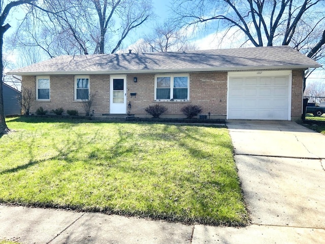 ranch-style home featuring an attached garage, driveway, a front lawn, and brick siding