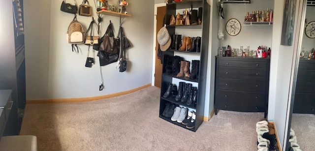 carpeted bedroom featuring a bar and baseboards