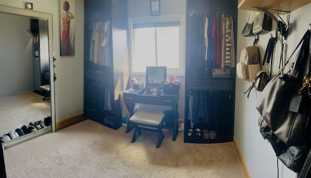 interior space featuring carpet flooring and baseboards