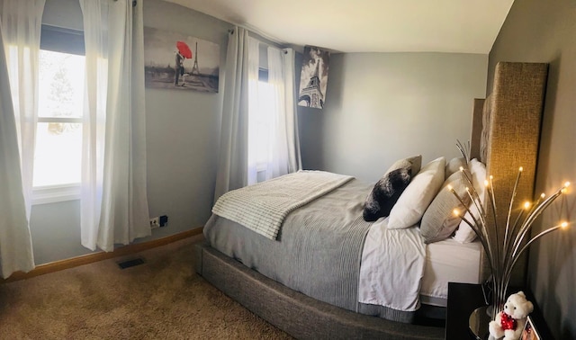 carpeted bedroom with multiple windows and visible vents
