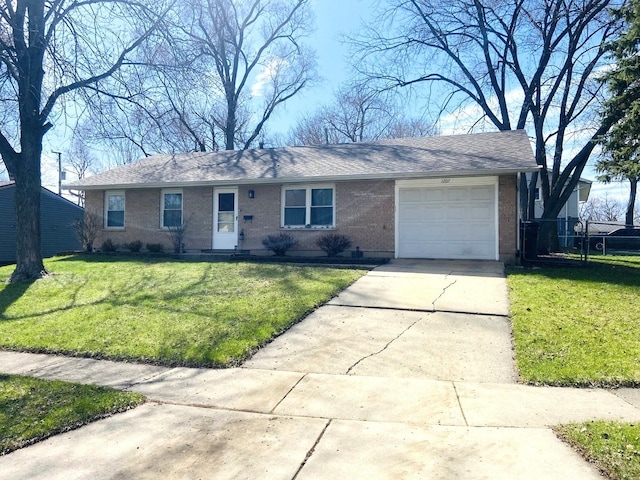 single story home featuring a garage, a front lawn, brick siding, a shingled roof, and driveway