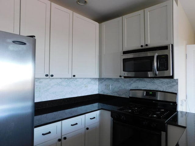 5300 N Lincoln Ave Unit 5A, Chicago, IL 60625 - kitchen featuring dark countertops, stainless steel appliances, and white cabinetry