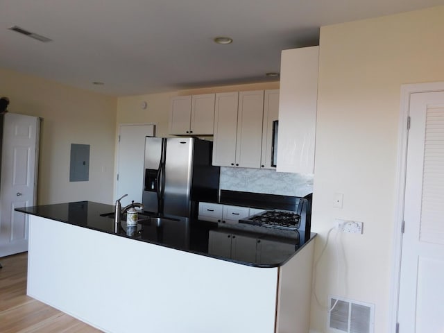 5300 N Lincoln Ave Unit 5A, Chicago, IL 60625 - kitchen with visible vents, electric panel, dark countertops, and stainless steel fridge with ice dispenser