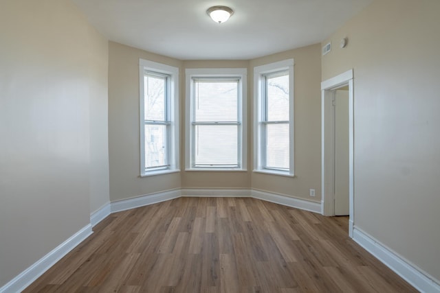 6609 S Rhodes Ave, Chicago, IL 60637 - unfurnished room featuring visible vents, baseboards, and wood finished floors