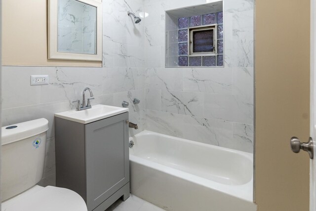 6609 S Rhodes Ave, Chicago, IL 60637 - bathroom with toilet, vanity, shower / washtub combination, and tile walls