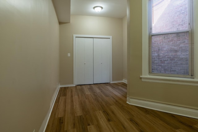 6609 S Rhodes Ave, Chicago, IL 60637 - unfurnished bedroom with a closet, baseboards, and wood finished floors