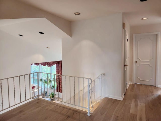 hall featuring recessed lighting, an upstairs landing, baseboards, and wood finished floors