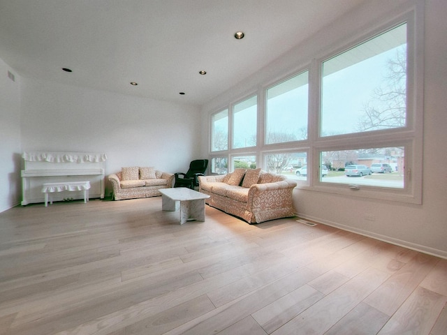 living room with visible vents, light wood-style flooring, and recessed lighting
