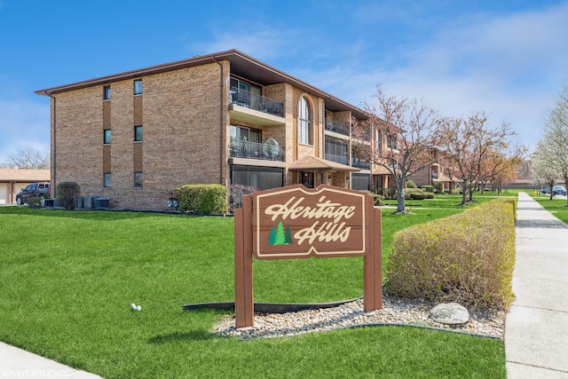 community sign featuring a lawn