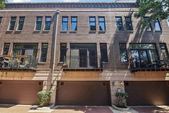 view of front facade featuring brick siding and an attached garage