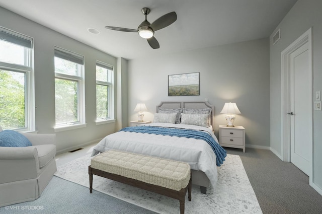 bedroom featuring visible vents, baseboards, a ceiling fan, and carpet
