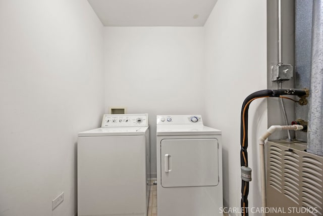 clothes washing area featuring laundry area and washer and clothes dryer