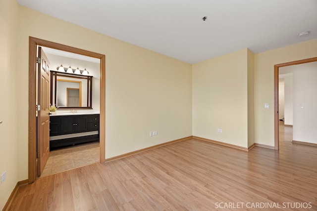 unfurnished room with light wood-style floors and baseboards