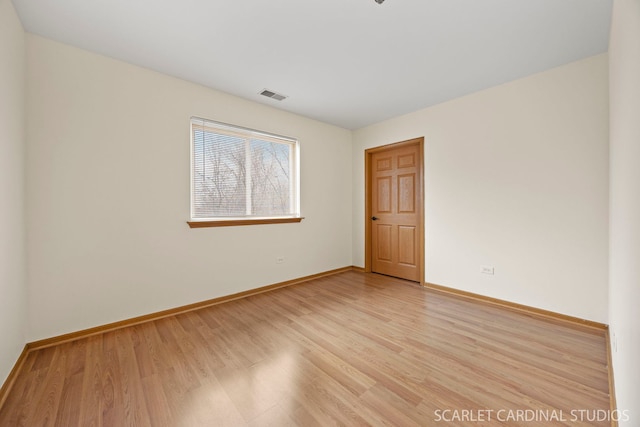 unfurnished room with visible vents, baseboards, and light wood-style floors