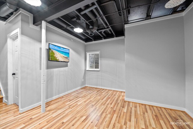 unfurnished room with baseboards and wood finished floors