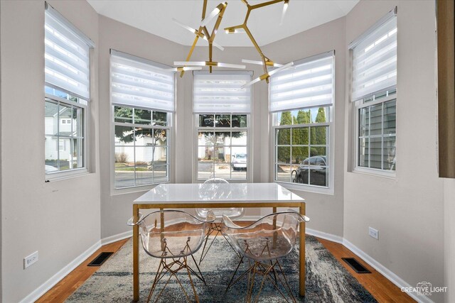 dining room with visible vents, baseboards, and wood finished floors