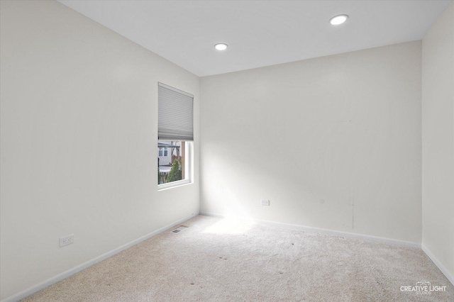 empty room featuring recessed lighting, carpet flooring, visible vents, and baseboards