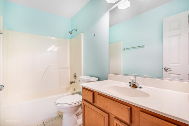 full bathroom featuring toilet, vanity, tile patterned flooring, and shower / washtub combination