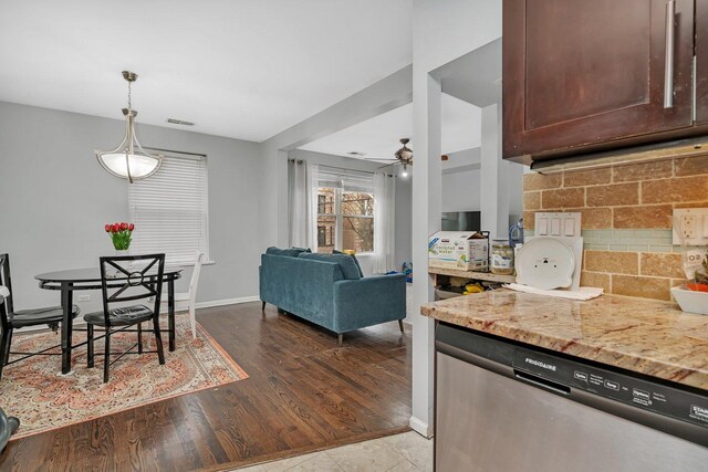 kitchen with tasteful backsplash, visible vents, dishwasher, wood finished floors, and light stone countertops
