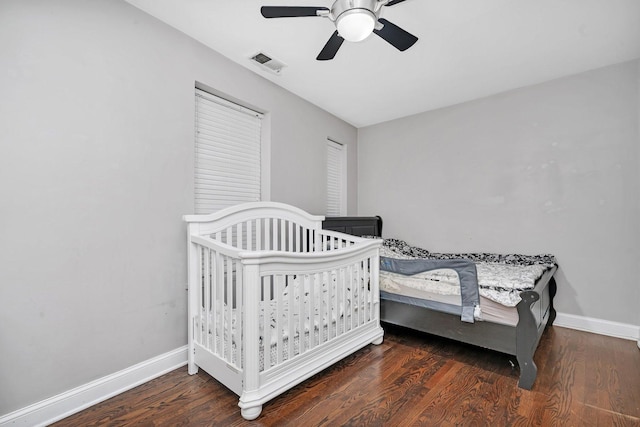 bedroom featuring wood finished floors, baseboards, and visible vents