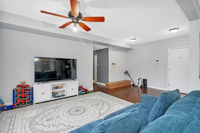 living room featuring ceiling fan, wood finished floors, and baseboards