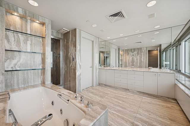 full bathroom with a whirlpool tub, visible vents, and double vanity