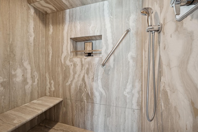 bathroom with a marble finish shower