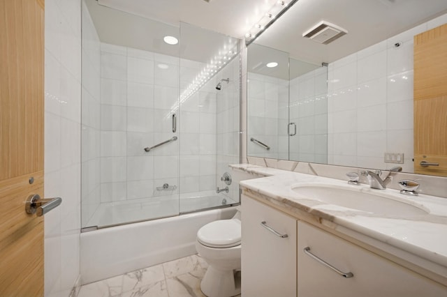 bathroom with visible vents, combined bath / shower with glass door, toilet, vanity, and marble finish floor