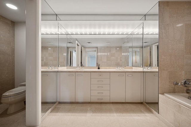 full bathroom featuring double vanity, a sink, and tile walls