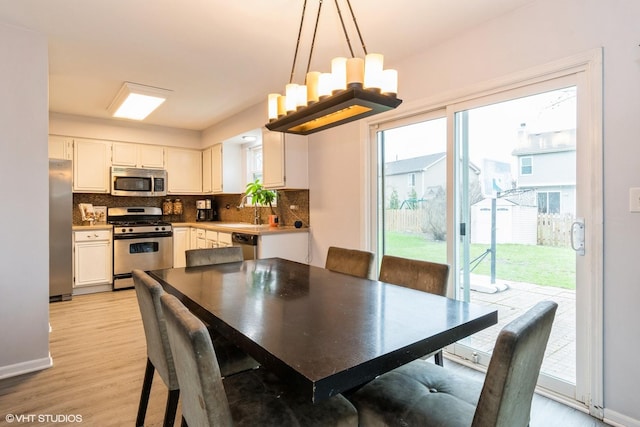 1164 Lakewood Cir, Naperville, IL 60540 - dining space featuring plenty of natural light, light wood-style flooring, and baseboards