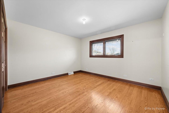 unfurnished room with visible vents, baseboards, and light wood-style floors