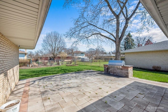 view of patio with grilling area, an outdoor kitchen, fence, and a playground
