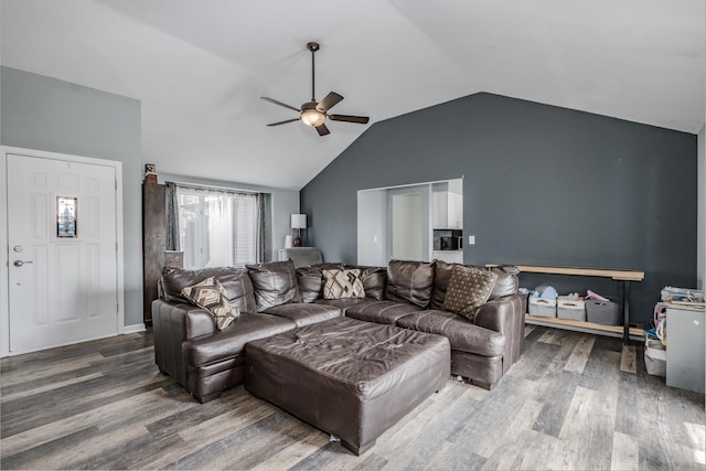living area with a ceiling fan, wood finished floors, and vaulted ceiling