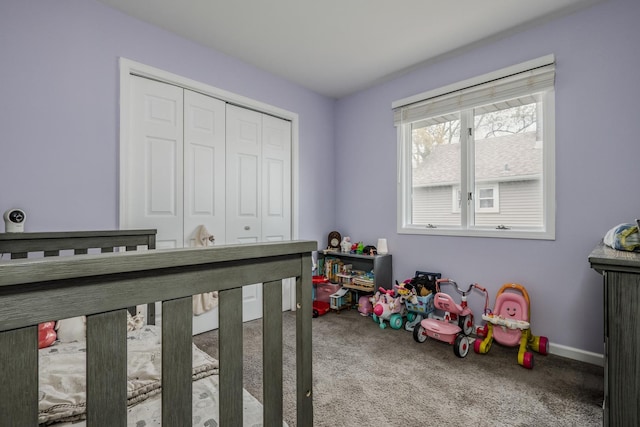 carpeted bedroom with baseboards and a closet